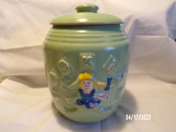 Product Image and Link for Vintage MCCOY Green Cookie Jar Rag Doll Girl Green Crock Stoneware 9″ Tall