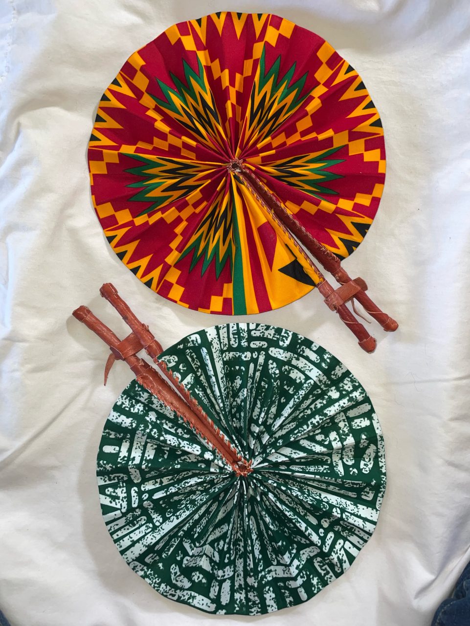 DESIGNS G1 OR G2: Bright African Kente folding fans w/ Leather Handles